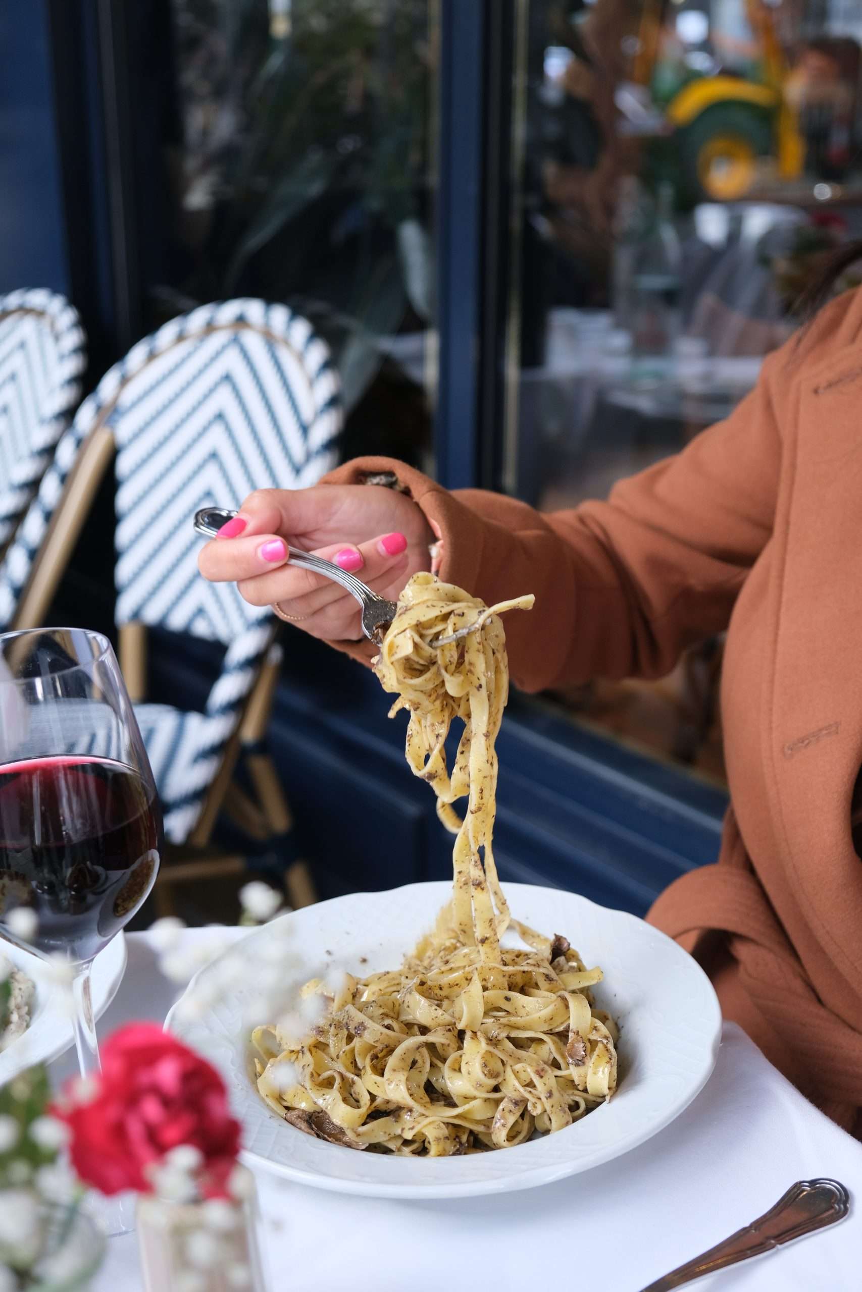 A plate of truffle pasta and a glass of wine