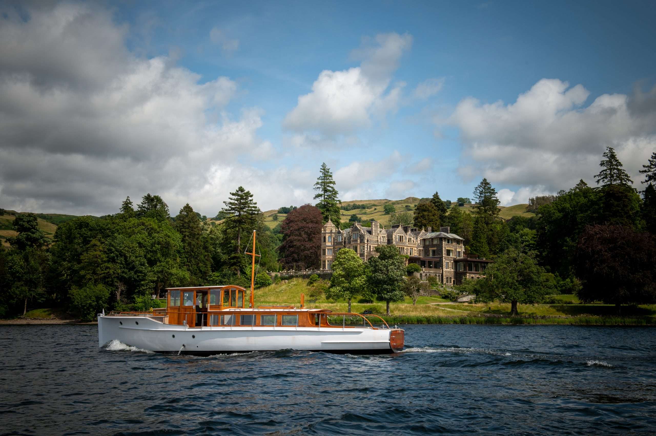 The Albatros, Langdale Chase Hotel's restored 1928 yacht, in front of Langdale Chase Hotel on the shores of Lake Windermere.