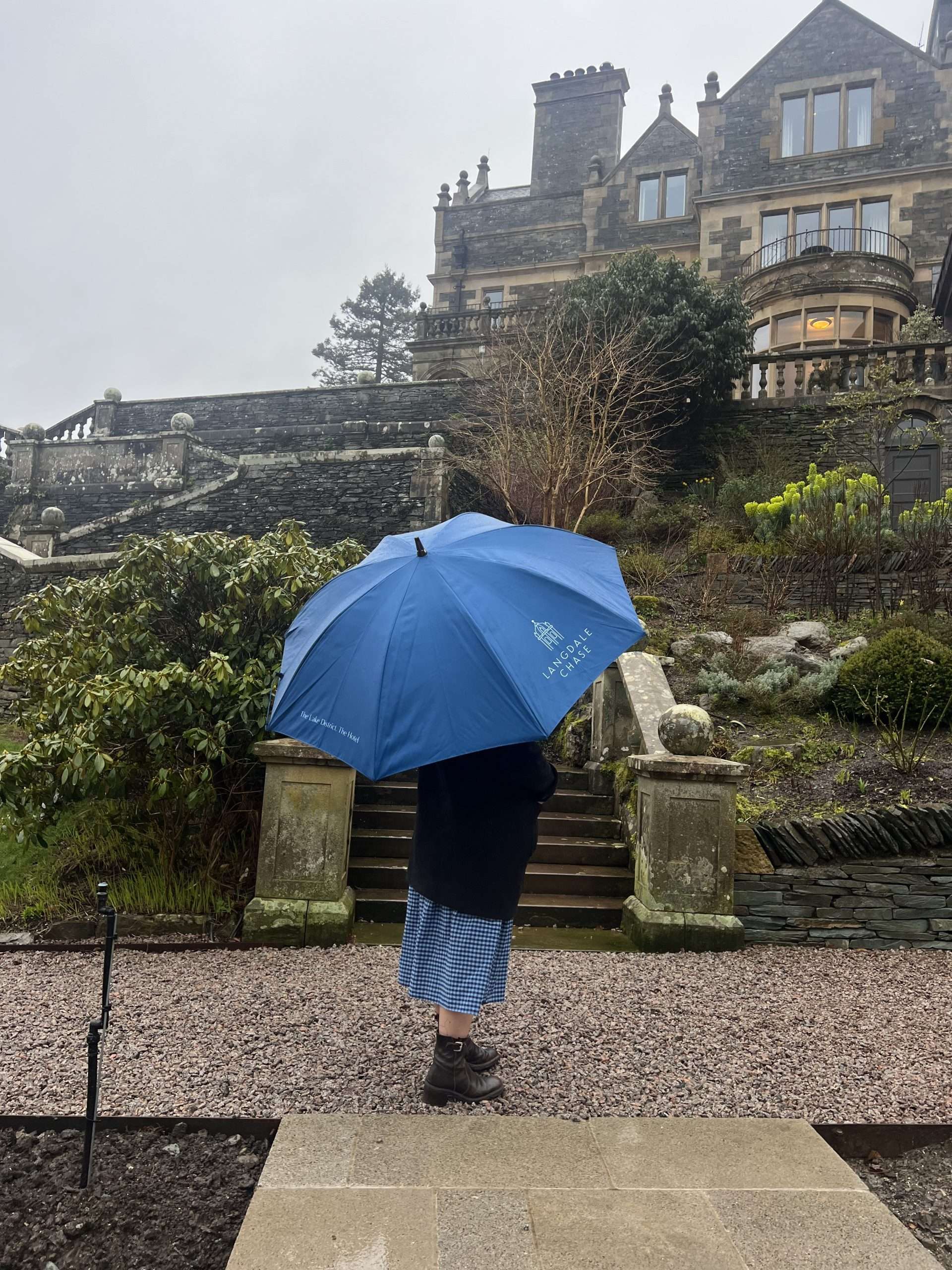 Outside Langdale Chase Hotel, admiring the grand building from the grounds.