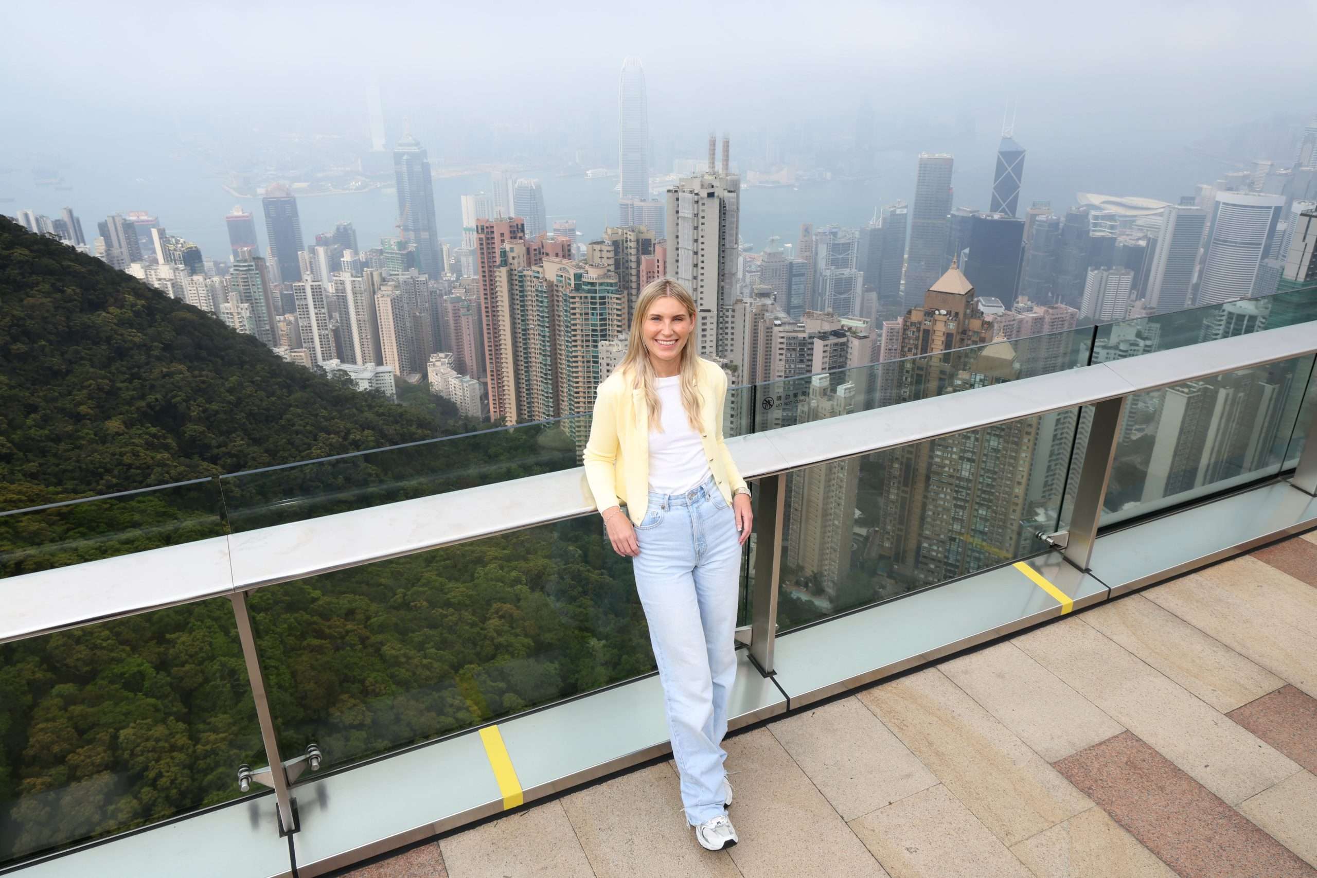 Travel Writer, Sally Seaton, with a backdrop of Hong Kong city 